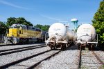 SQVR 3002 poses next to some tank cars